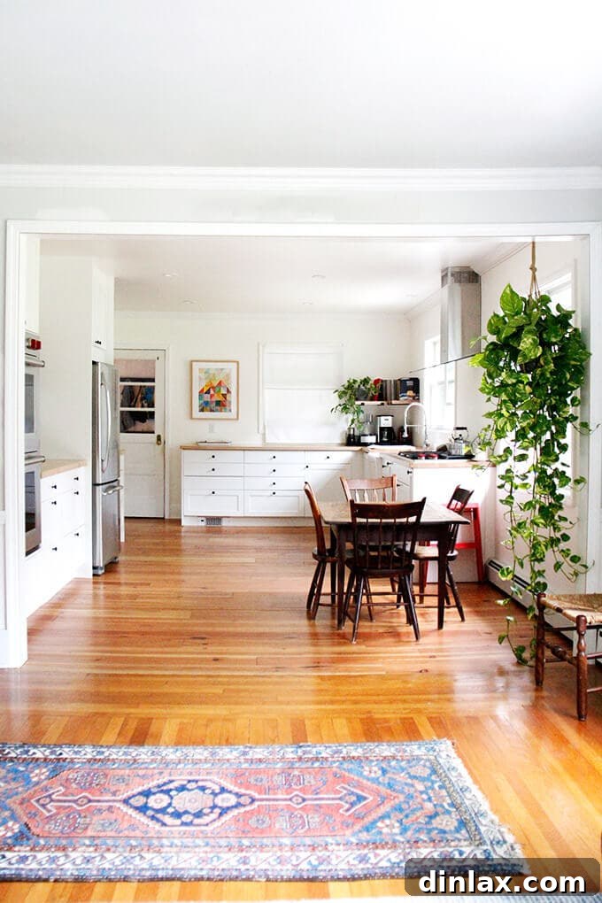 A bright, newly remodeled kitchen with butcher block countertops, white shaker cabinets, and open shelving.