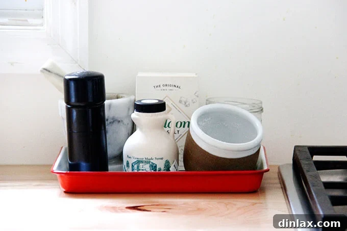 Falcon Enamelware trays neatly organizing spices and oils on a kitchen countertop.