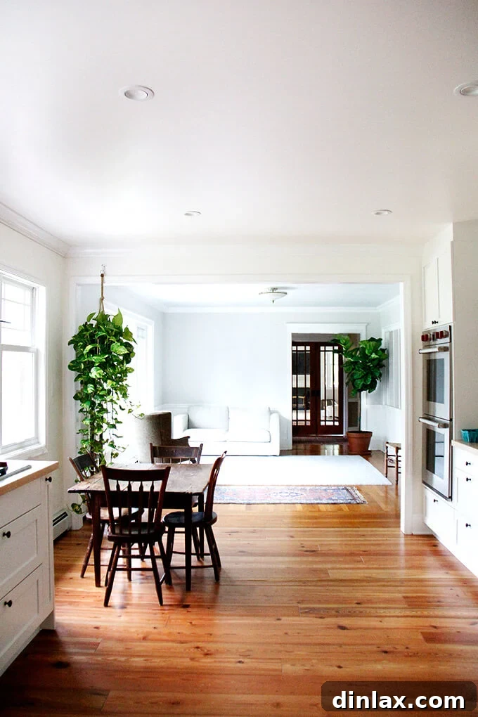Close-up of modern kitchen with a large range and hood, featuring open shelves with cookbooks.