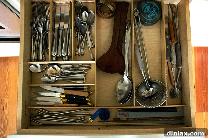 Kitchen drawer featuring a comprehensive utensil divider system for various tools.