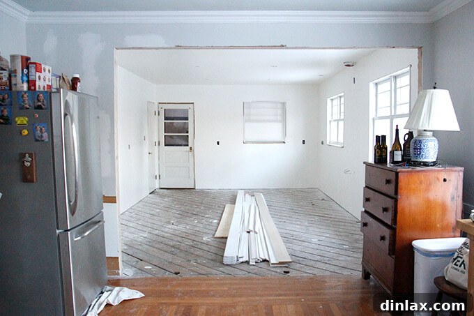 Kitchen walls being painted, transforming the space with a fresh coat of color