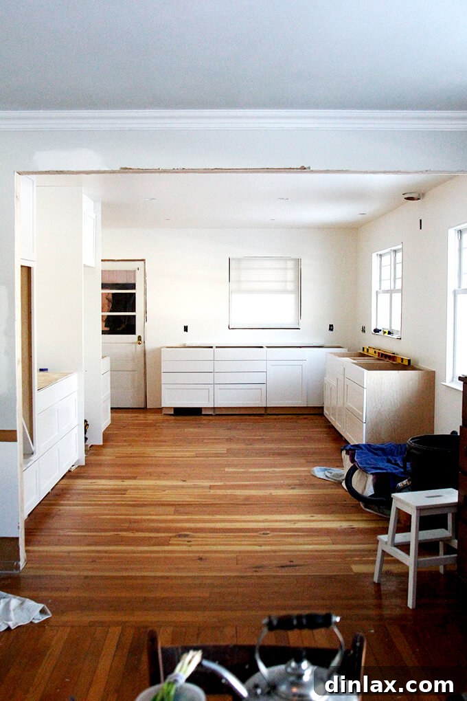 Kitchen renovation nearing completion, with walls and floor finished, awaiting final installations