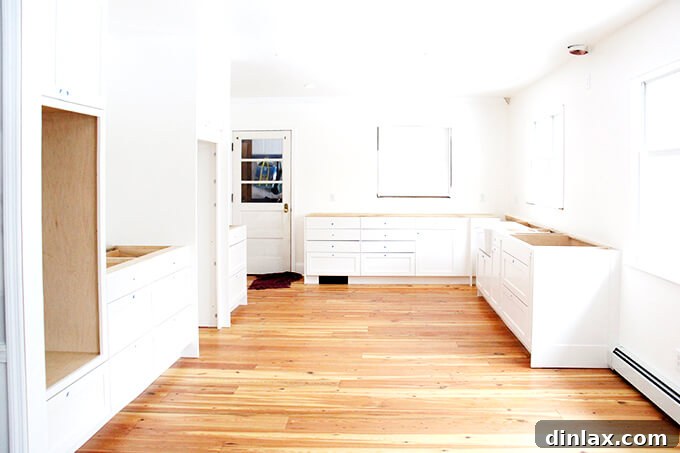 Kitchen cabinets being installed, providing essential storage and defining the room's layout