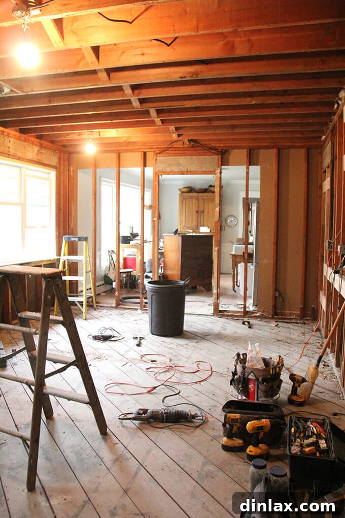 Old kitchen flooring completely removed, revealing the subfloor and ready for new installation