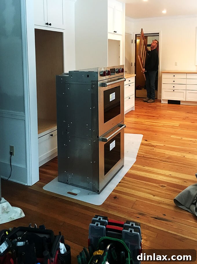 New ovens being installed in the kitchen, completing the cooking appliance setup