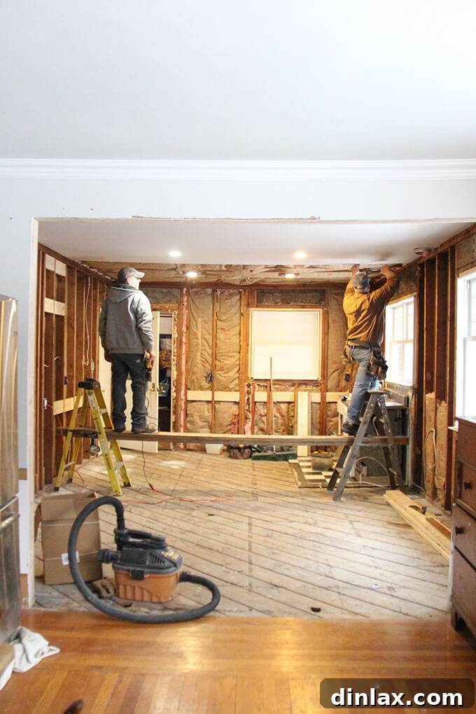 New ceiling panels being installed in the kitchen, forming a clean overhead surface