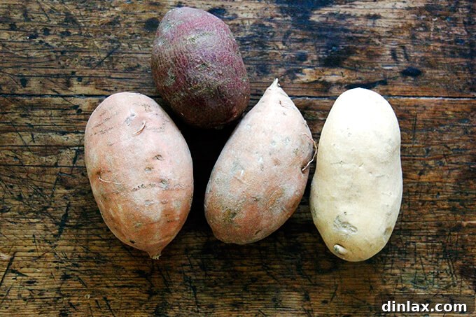 A board of raw sweet potato slices, ready for roasting.