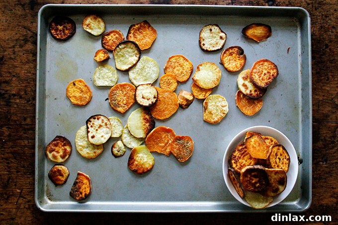 Golden-brown toasted sweet potatoes on a board, showcasing crispy edges.
