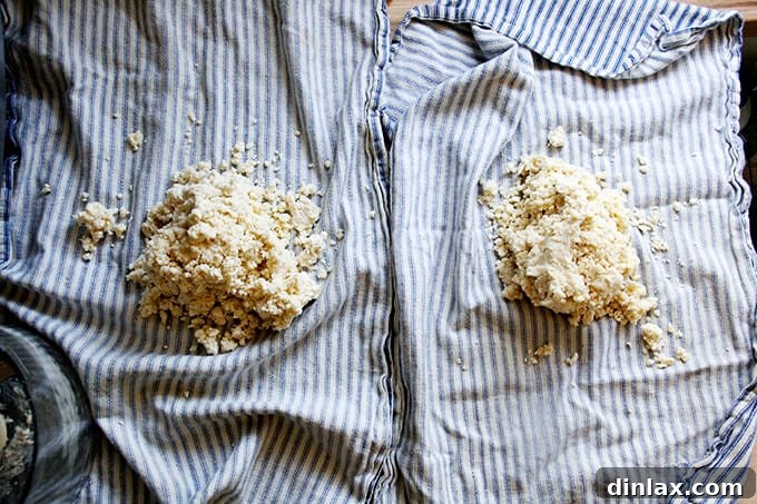 Rustic Rhubarb Frangipane Galette 11 Two neatly folded tea towels, each containing a portion of the freshly processed pastry dough.