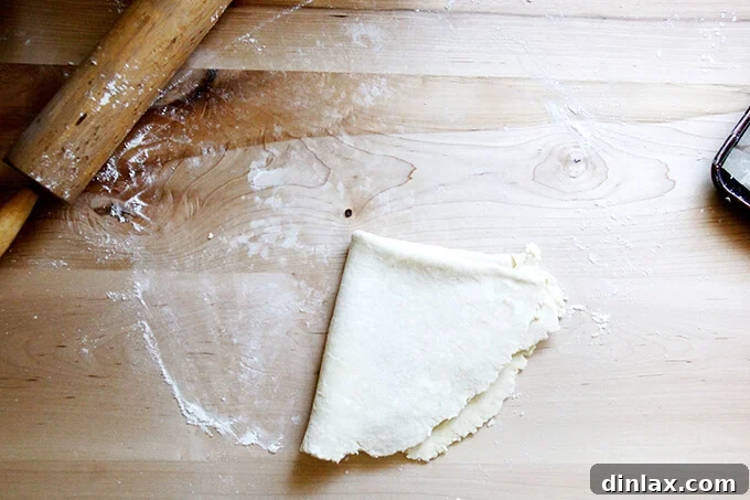 Rustic Rhubarb Frangipane Galette 16 The perfectly rolled-out pastry dough, thoughtfully folded into quarters for effortless transfer to the baking sheet.