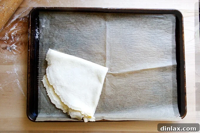 Rustic Rhubarb Frangipane Galette 17 A pristine sheet pan, lined with parchment paper, awaits the arrival of the rolled-out pastry dough.