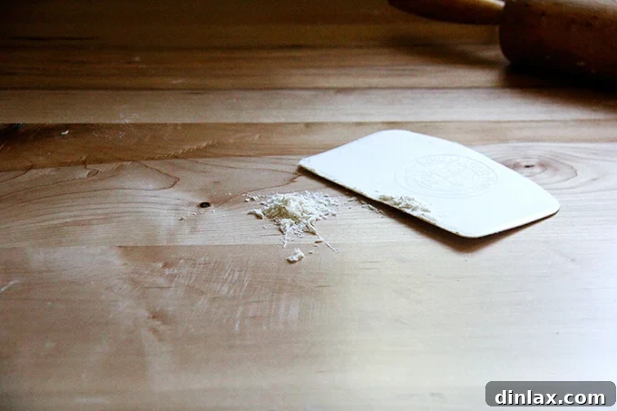 Rustic Rhubarb Frangipane Galette 19 A versatile bench scraper, a baker's essential, rests on a clean counter.