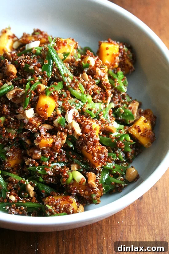 Vibrant quinoa salad with sweet mango, crisp snap peas, fresh ginger, and zesty lime.