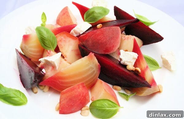 Elegant roasted beet, peach, and goat cheese salad with a vibrant dressing.