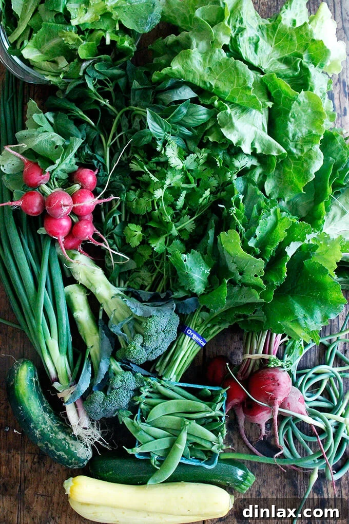 Freshly picked basil stored in a glass of water, a common tip for extending its freshness in a CSA share