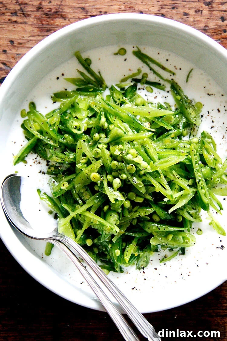 Vibrant snap pea salad with buttermilk dressing, a refreshing summer dish featuring thinly sliced peas with lemon zest and olive oil