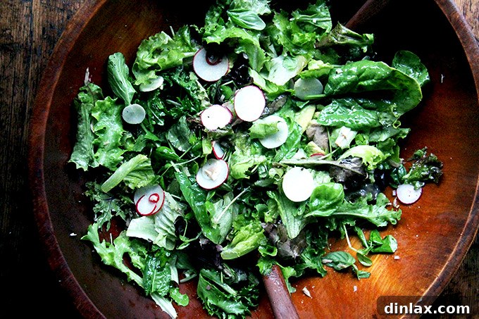 Simple green salad with shaved radishes, turnips, and scallions, dressed with a shallot vinaigrette
