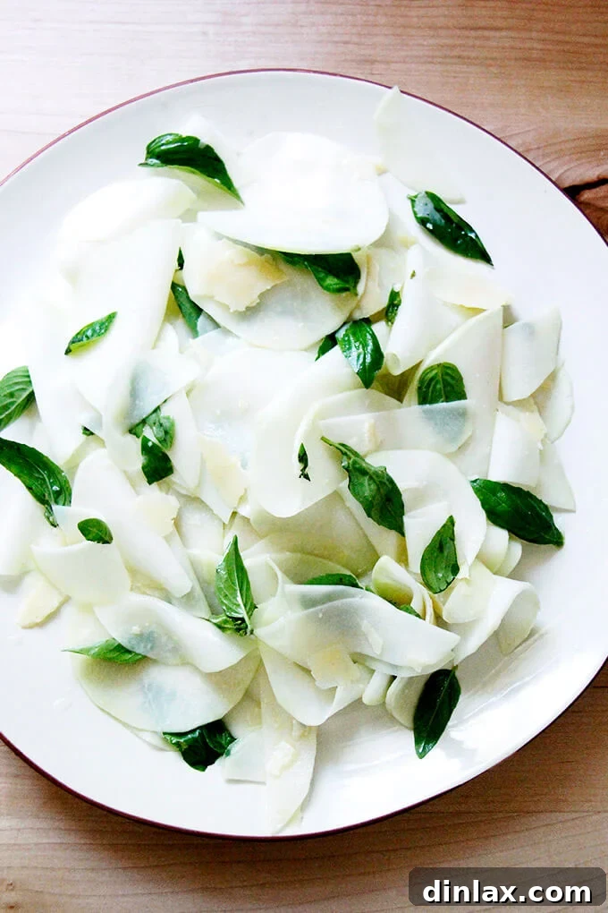 A platter of shaved Kohlrabi Salad with basil and parmesan. A light, fresh salad perfect for summer.