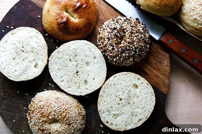 Freshly baked bagels, sliced in half, revealing their dense, chewy interior and inviting texture.