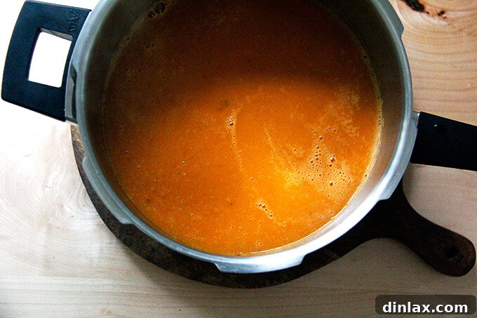 Adding fresh basil and puréeing again.