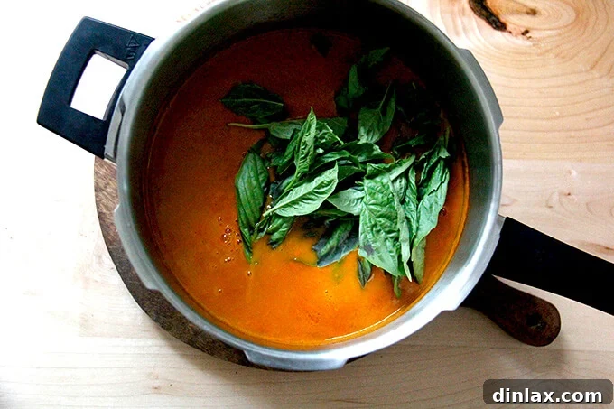 Simmering the puréed tomato sauce on the stovetop.