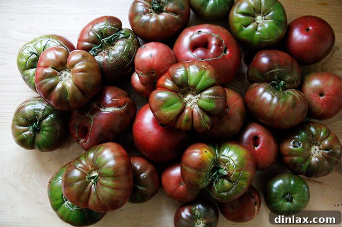 Large, ripe tomatoes on a cutting board, ready to be chopped.