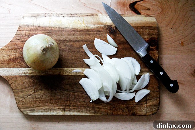 Chopped tomatoes added to a pressure cooker pot.