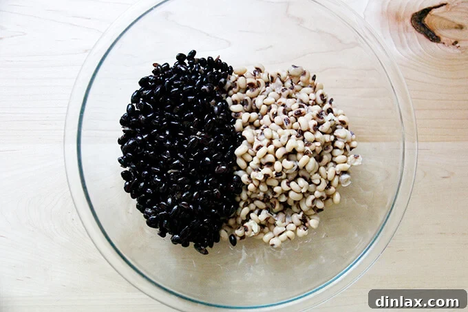 A large bowl containing a mixture of cooked black beans and black eyed peas, ready for the next steps.