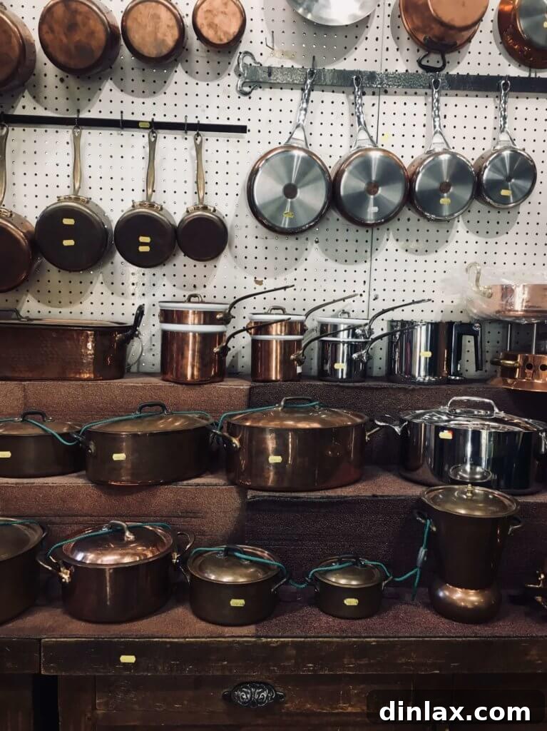 Parisian Gems 33 Rows of copper pots and pans hanging from the ceiling at E. Dehillerin, showcasing its vast collection.