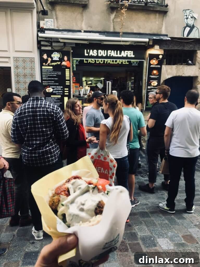 Parisian Gems 42 The famous falafel wrap from L'As du Fallafel, brimming with ingredients.