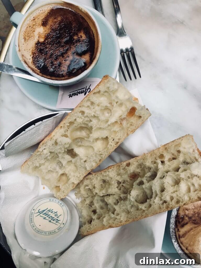 Parisian Gems 52 A close-up of the perfect breakfast spread, with fresh baguette and butter.