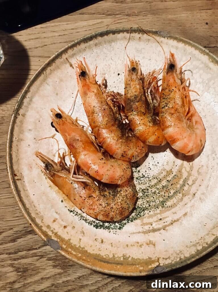 Parisian Gems 54 A close-up of delectable shrimp served at Au Passage, garnished beautifully.