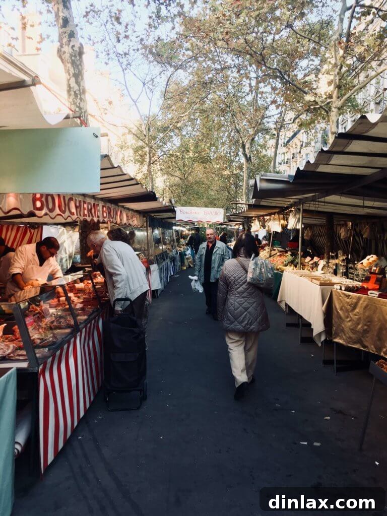 Parisian Gems 63 A typical Parisian street scene with people walking and charming buildings.