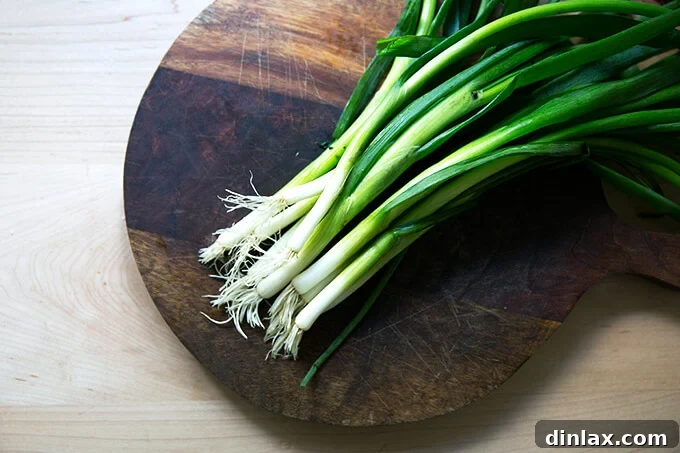 Chinese Steamed Scallion Twists 9 A board with fresh scallions, ready to be sliced.