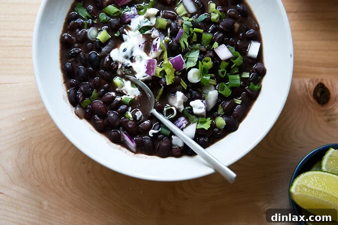 Hearty Black Bean Soup 13 A delectable bowl of black bean soup generously adorned with all its fresh garnishes, inviting one to dig in and enjoy the layered flavors.