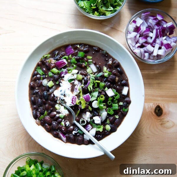 A bowl of Cal Peternell's black bean soup with garnishes.