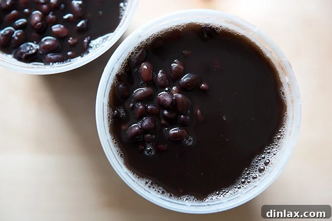 Hearty Black Bean Soup 3 Two quart containers holding perfectly pressure-cooked black beans, showcasing their ideal texture and readiness for soup making.