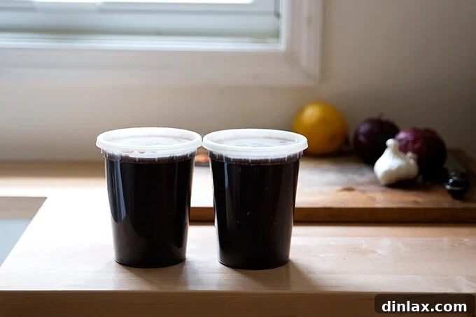 Hearty Black Bean Soup 9 Two quart containers, one filled with cooked black beans and the other with their flavorful cooking liquid, ready to be added to the soup.