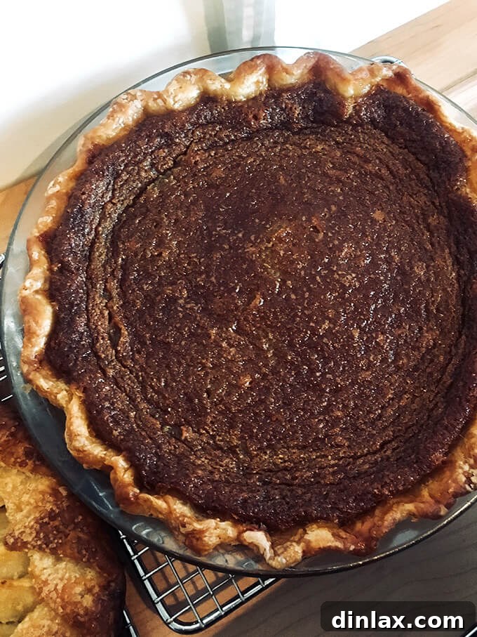Sister Pie's Irresistible Salted Maple Pie 17 An inviting overhead shot of Sister Pie's Salted Maple Pie, just baked, displaying its golden-brown crust and perfectly set custard, ready to be enjoyed.