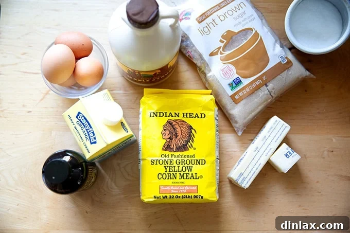 Sister Pie's Irresistible Salted Maple Pie 3 A collection of ingredients laid out, including maple syrup, butter, cornmeal, brown sugar, eggs, heavy cream, and vanilla, ready to make a delicious salted maple pie.