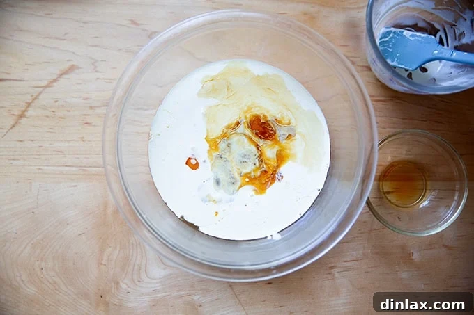 Sister Pie's Irresistible Salted Maple Pie 8 A separate bowl holding heavy cream, a splash of vanilla, and several eggs, waiting to be whisked together into a smooth blend.