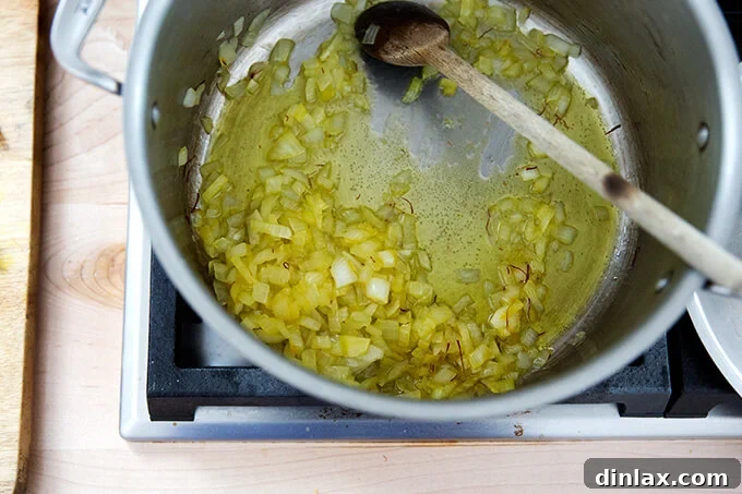 Golden Velvet Carrot Saffron Soup with Almond Dukkah Crunch 6 Onions gently sweating in olive oil with fragrant saffron.