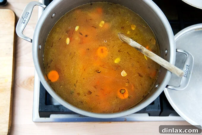 Golden Velvet Carrot Saffron Soup with Almond Dukkah Crunch 7 Carrots, water, saffron, onions, and almonds simmering on the stovetop.