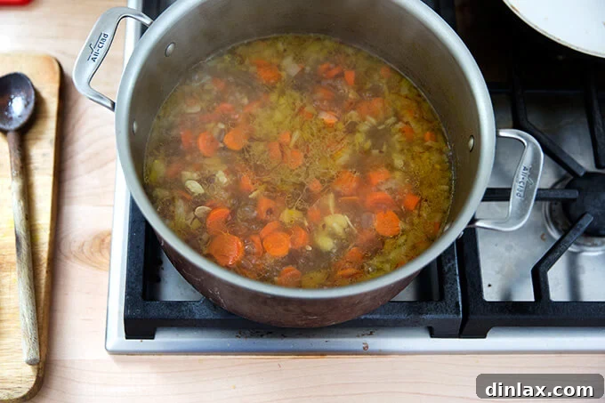 Golden Velvet Carrot Saffron Soup with Almond Dukkah Crunch 8 Close-up of carrots, water, saffron, onions, and almonds simmering to perfection.