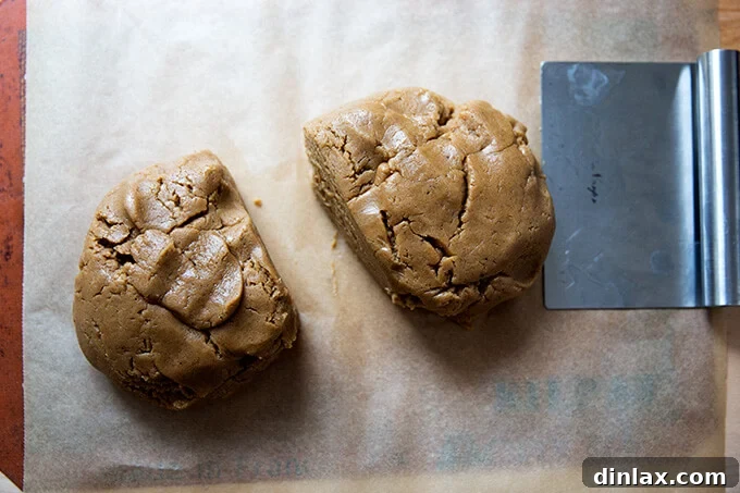Brown Butter Muscovado Stamped Christmas Cookies 7 mixed dough divided in two portions on a silpat lined cookie sheet with a bench scraper.