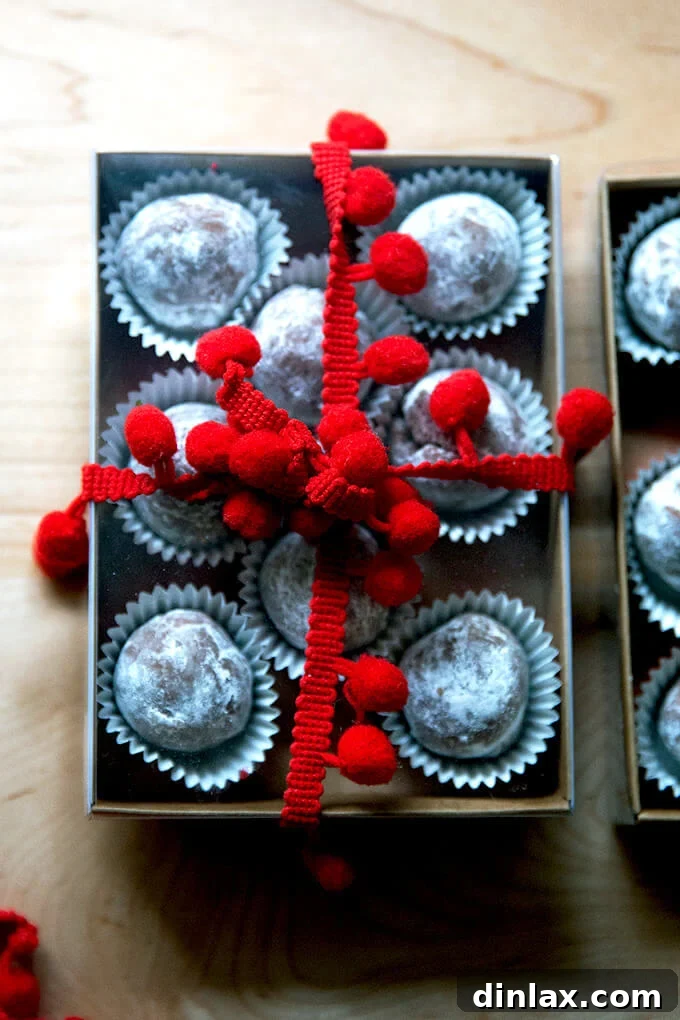 Quick and Boozy Holiday Rum Ball Delight 17 Close-up of individual rum balls beautifully wrapped in decorative foil, making them ideal for gifting.