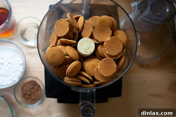 Quick and Boozy Holiday Rum Ball Delight 5 Vanilla wafers being pulsed in a food processor, turning into fine crumbs for rum balls.