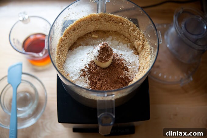 Quick and Boozy Holiday Rum Ball Delight 7 Cocoa powder, confectioners' sugar, and corn syrup added to the ground vanilla wafers in a food processor for rum balls.