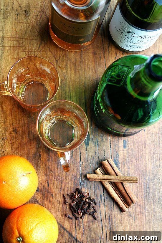 Aunt Betsy's Signature Glogg 2 Various ingredients for making glogg, including oranges, cinnamon sticks, and bottles of wine and port