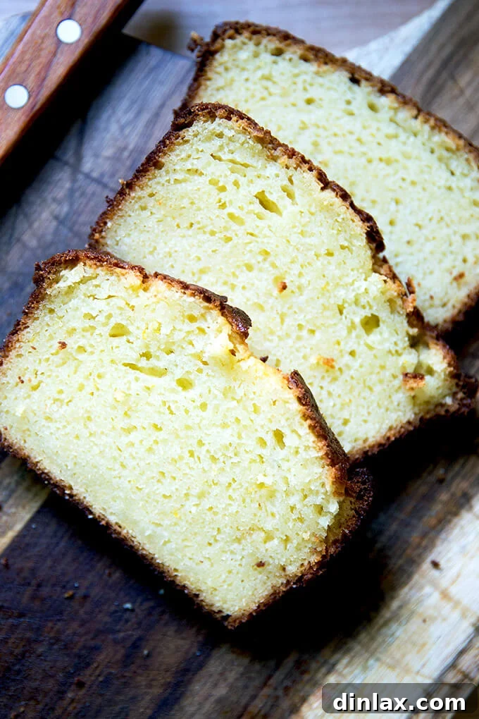 Multiple slices of orange ricotta pound cake arranged beautifully on a serving plate, highlighting its golden crust and inviting texture, ready to be enjoyed.
